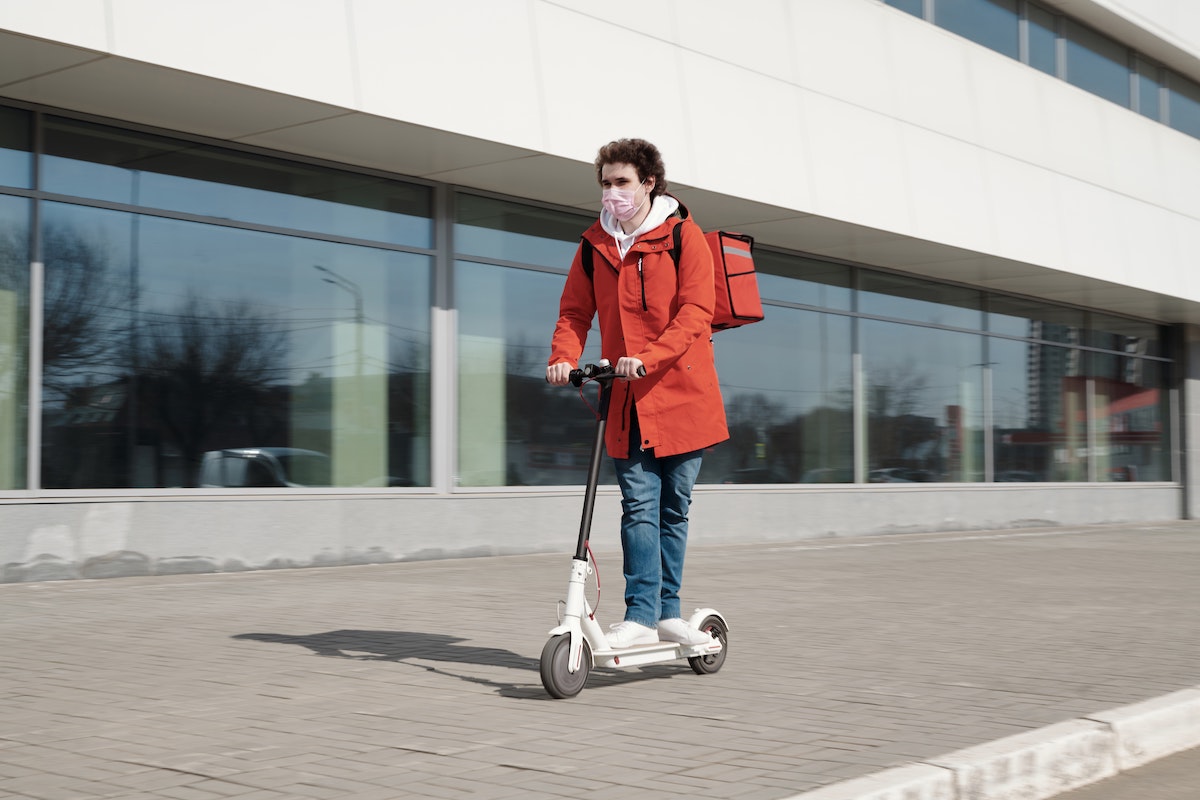 Scooter rider wearing mask